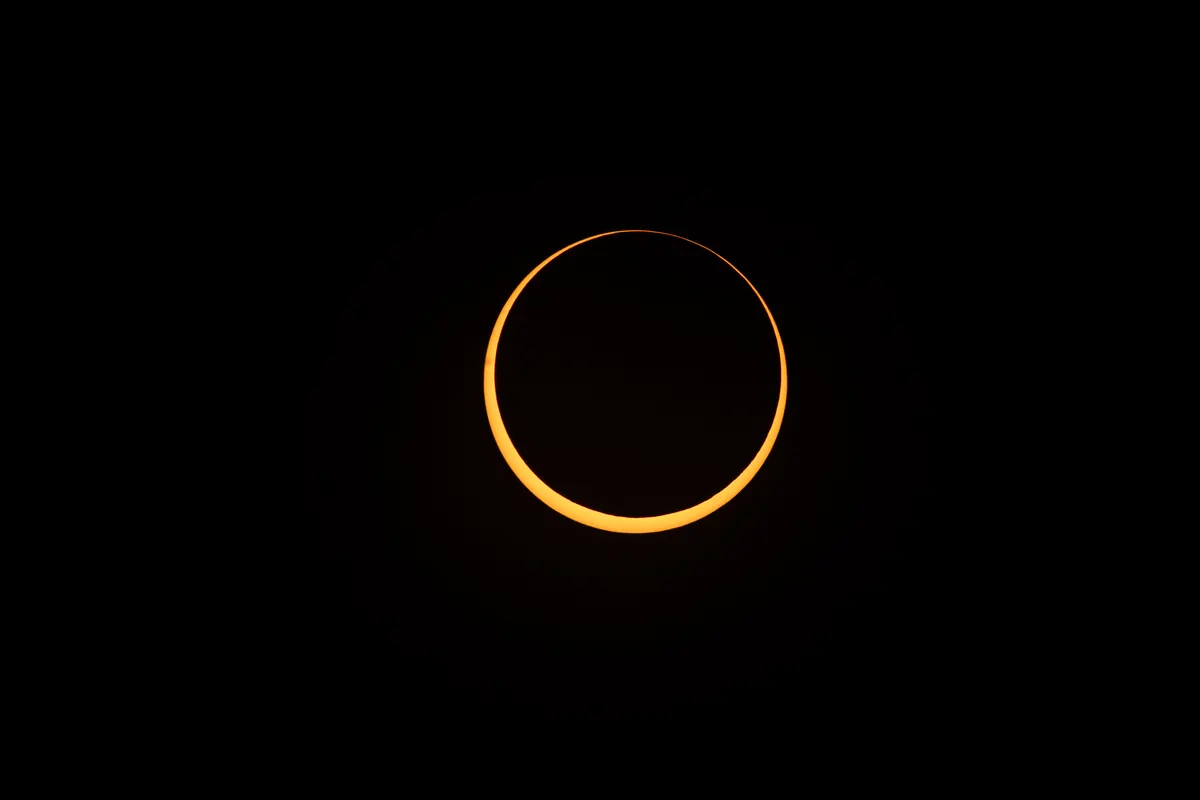 A thin bright ring of sunlight around the dark disc of the Moon during an annular solar eclipse