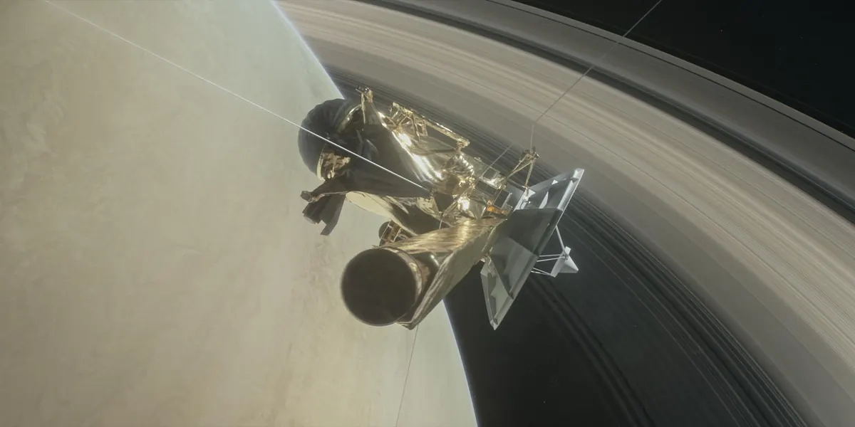 An illustration of the Cassini spacecraft diving through the gap between Saturn and its rings