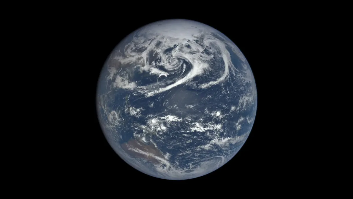 Earth as a blue and white disk with swirling clouds