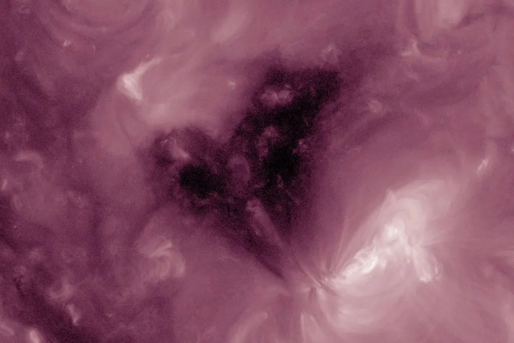 A heart-shaped dark patch in the Sun's outer atmosphere, seen in extreme ultraviolet light