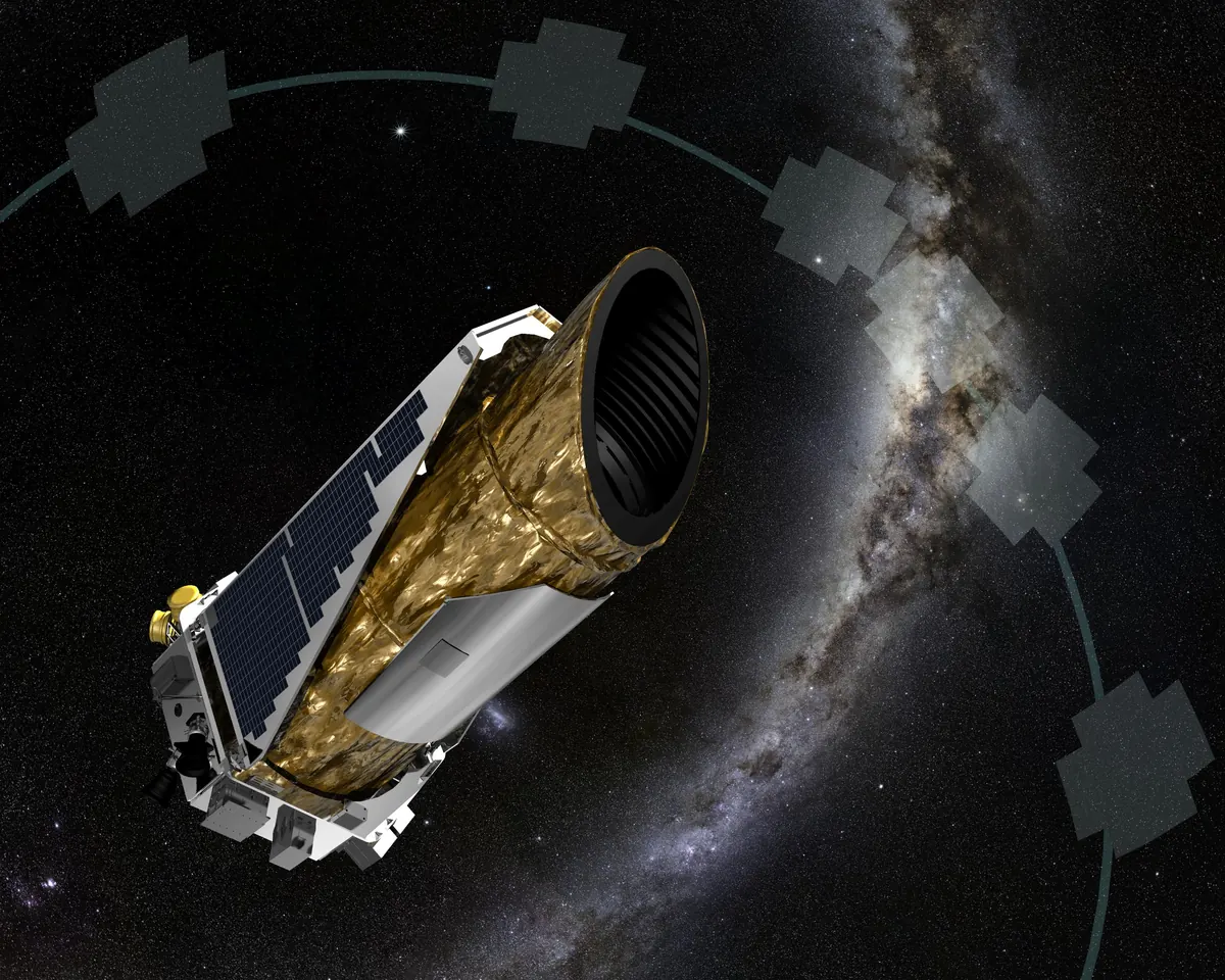 The Kepler spacecraft with its gold telescope tube and solar panel wing against a starry sky