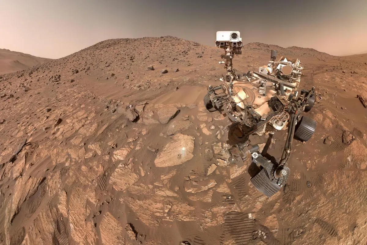 The Perseverance rover on a rocky Martian slope, taking a selfie