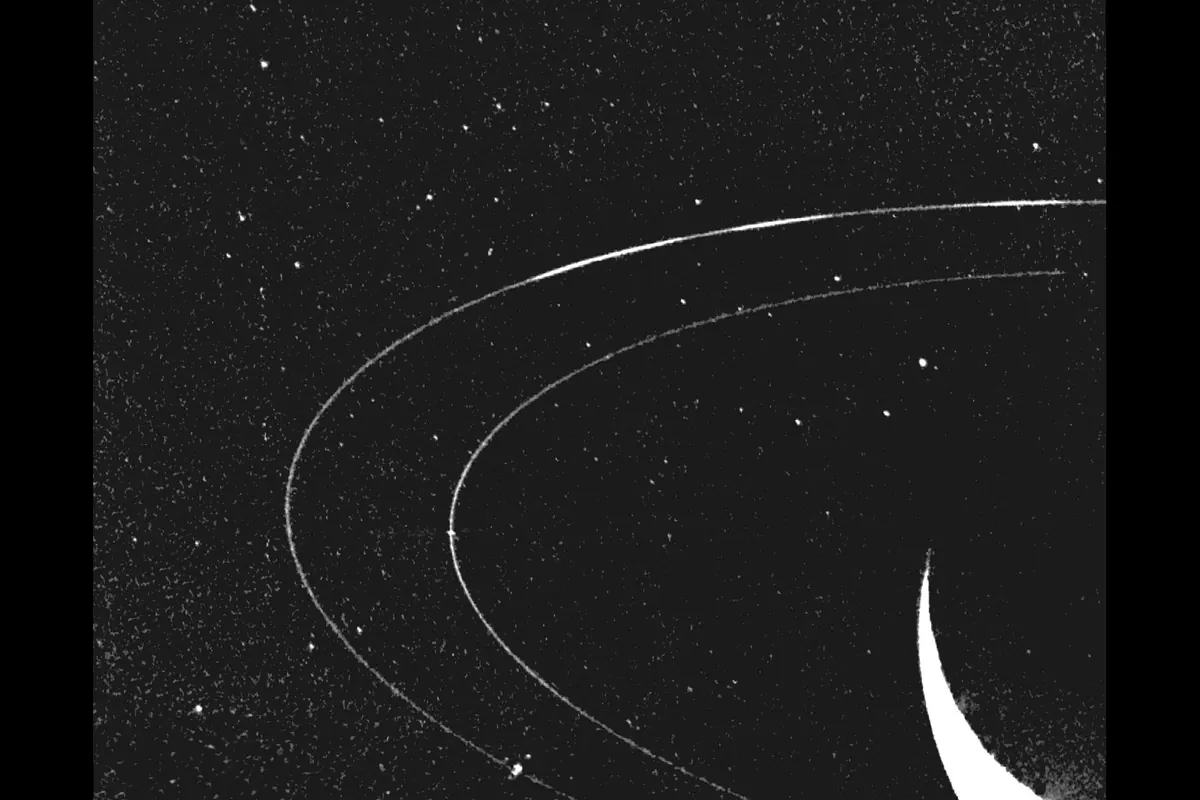 Two faint curved rings around Neptune on a starry black background