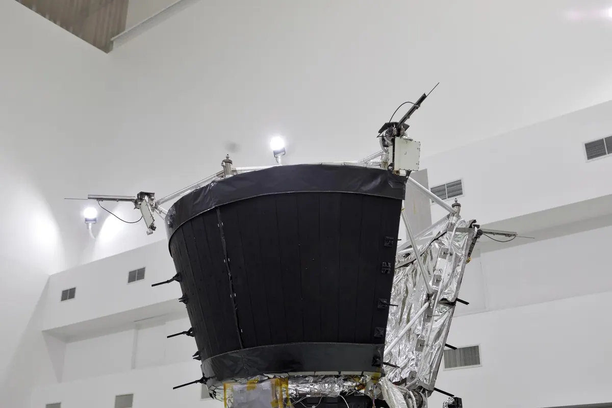 The Parker Solar Probe spacecraft in a clean room, with its round black heat shield and silver antennas