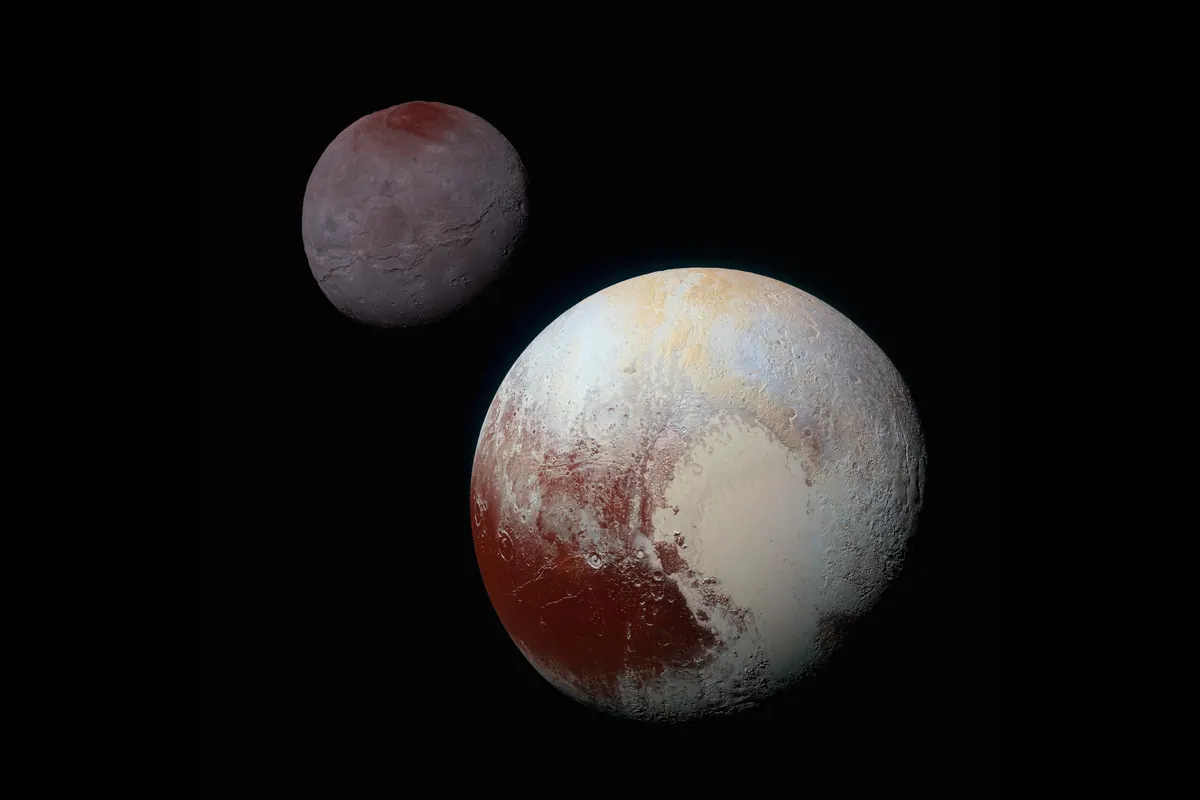 Pluto, with red-brown and cream patches, beside its smaller gray moon Charon