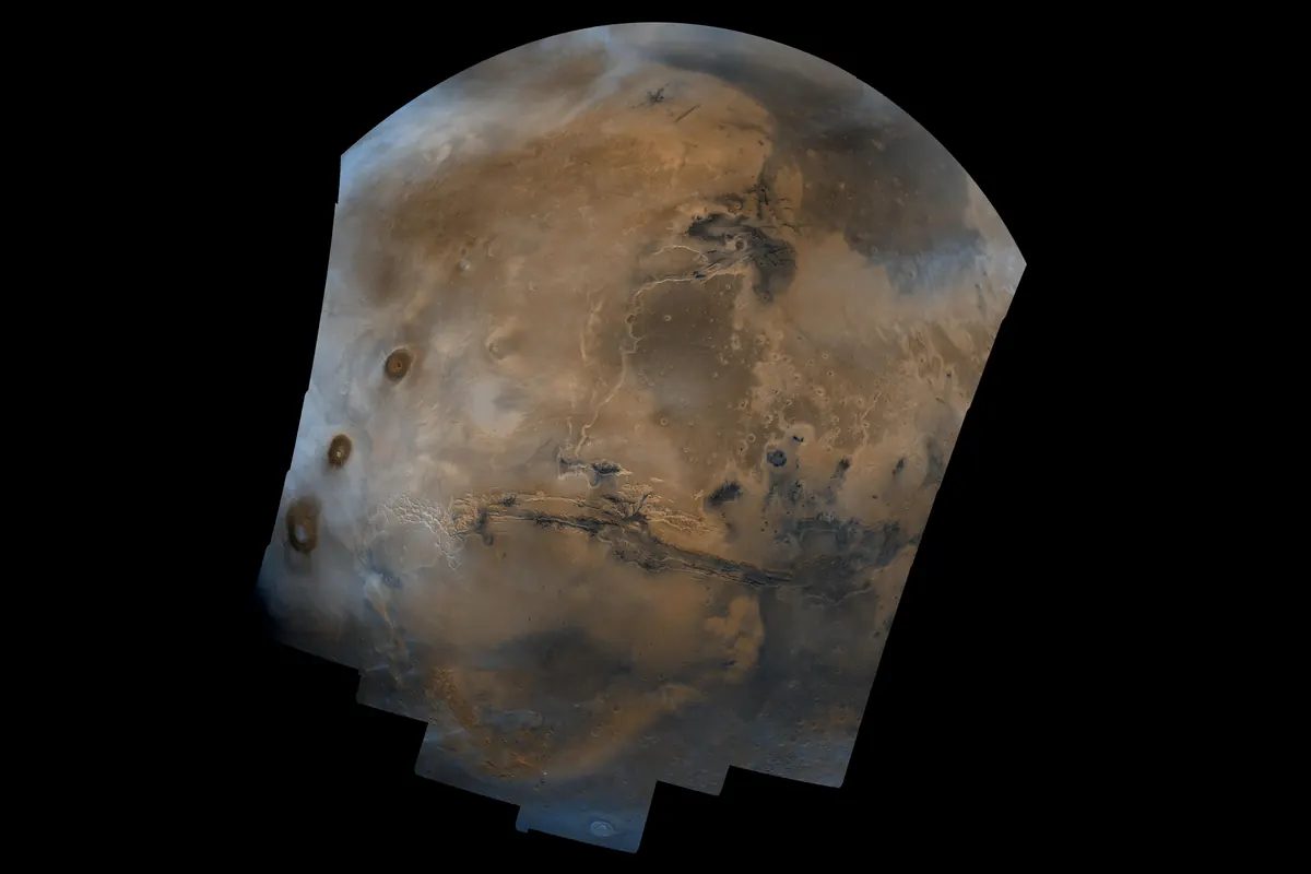 A mosaic of Mars with the long Valles Marineris canyon across the middle of a rust-orange planet